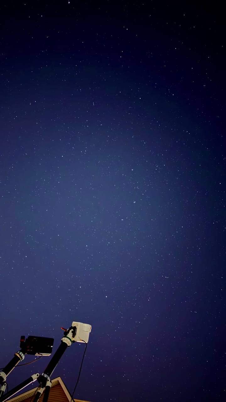 A Seestar telescope pointed at a starry sky.